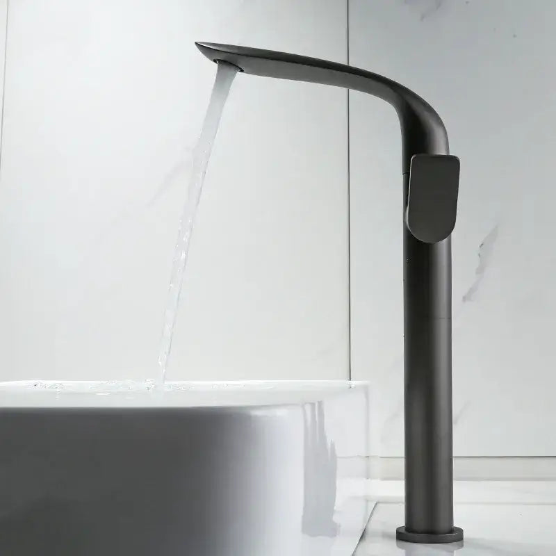 Modern gold and black decorbites basin faucet with matte black finish and sleek curved tall cylindrical design