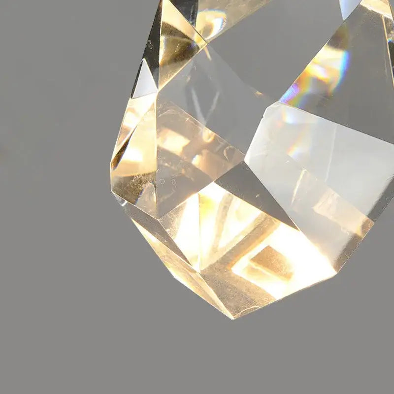 Modern gold and black crystal wall sconce featuring a faceted transparent crystal pendant with subtle golden reflections decorbites crystal wall