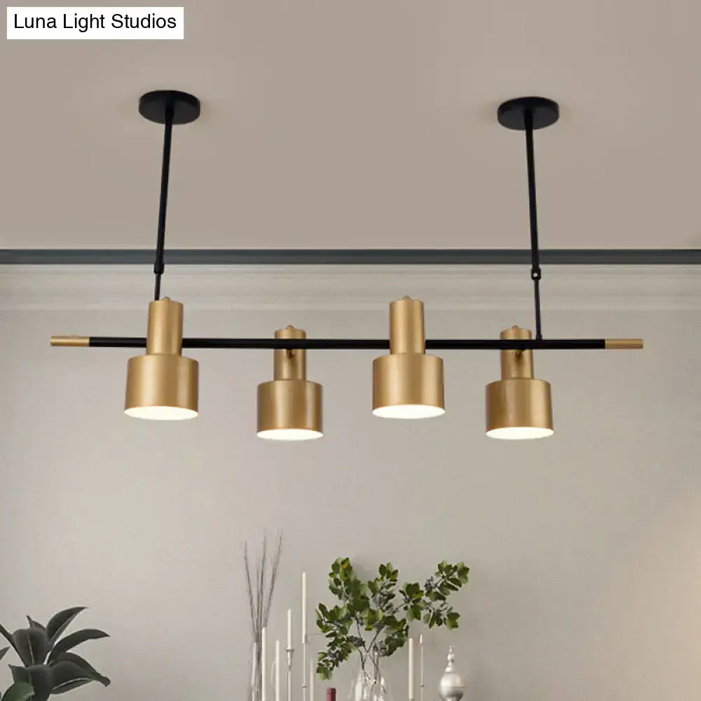 Modern gold and black drum pendant light with cylindrical shades for dining room island illumination