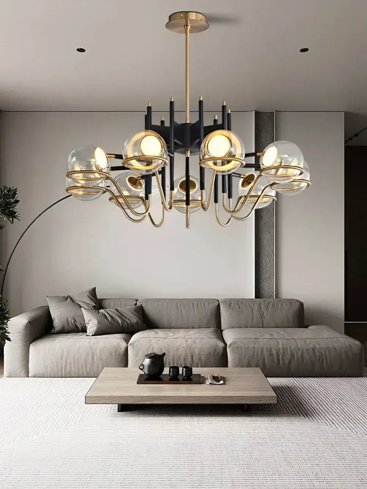 Modern gold and black glass ball pendant light featuring gold-toned metal arms and spherical glass globes for living room decorbites glass ball pendant