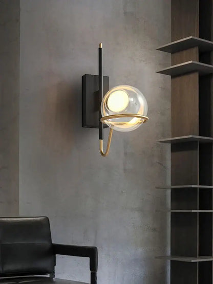 Modern gold and black glass ball pendant light with clear glass globe and metal frame mounted on black backplate for living room decorbites glass ball pendant