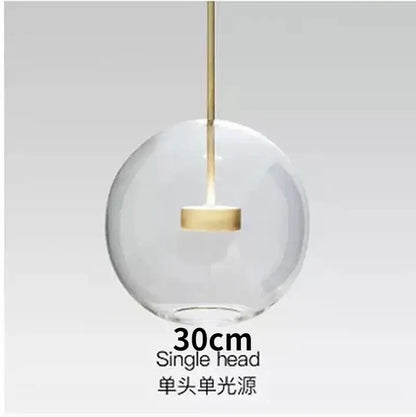Modern gold and black glass chandelier featuring a clear glass globe pendant light with a gold-toned metal stem decorbites glass chandelier