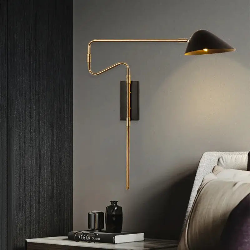 Modern gold and black led wall lamp with sleek curved arm and black conical shade for bedroom lighting