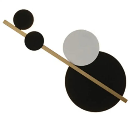 Modern gold and black led wall lamp with minimalist abstract wall art featuring black and white circles and a gold rod