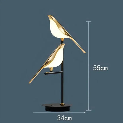 Modern gold and black magpie bird pendant light with gold-toned illuminated bodies and iron finish for dining room cord pendant installation