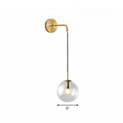 Modern gold and black spherical glass wall light featuring a gold-toned wall sconce with a light bulb and black cord