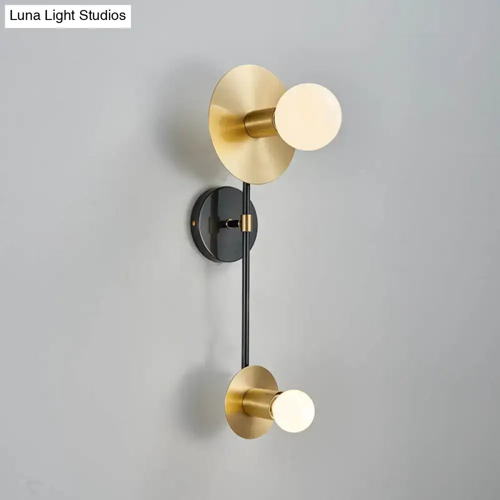 Modern gold and black wall sconce with brushed gold opal glass shade and sleek black rod for bedroom lighting