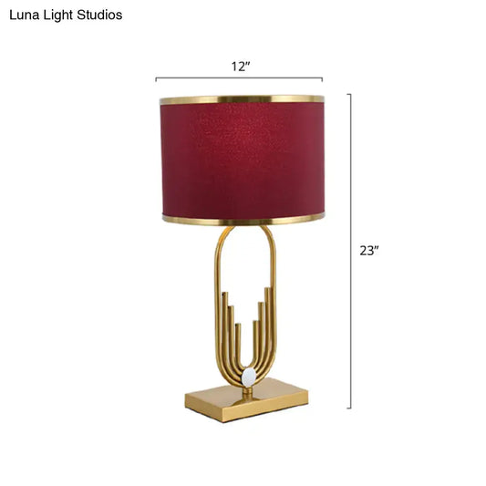 DecorBites™ red fabric drum nightstand lamp with a gold-toned base and textured burgundy shade for bedside lighting
