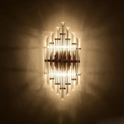 Modern gold and clear crystal led wall sconce with brass finish and vertical glass tubes for bedroom decorbites crystal led lighting