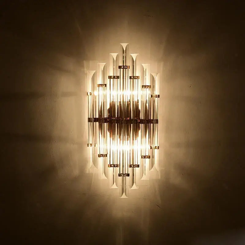 Modern gold and clear crystal led wall sconce with brass finish and vertical glass tubes for bedroom decorbites crystal led lighting