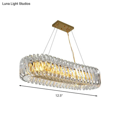 Elegant modern gold pendant light with clear crystal faceted segments designed for dining room illumination