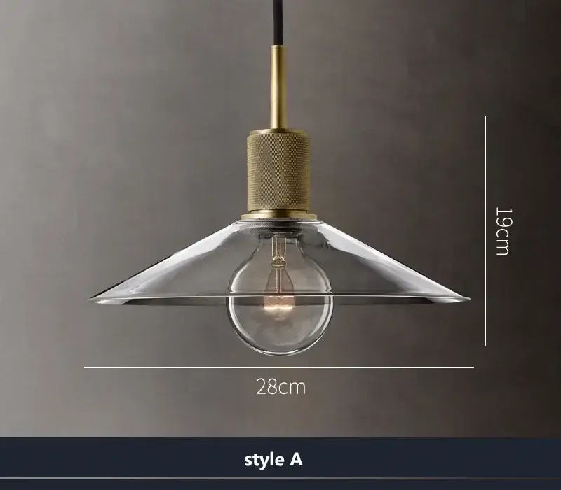 Modern gold and clear glass led pendant light with brass hardware and exposed bulb for dining room illumination
