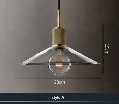Modern gold and clear glass led pendant light with brass hardware and exposed bulb for dining room illumination