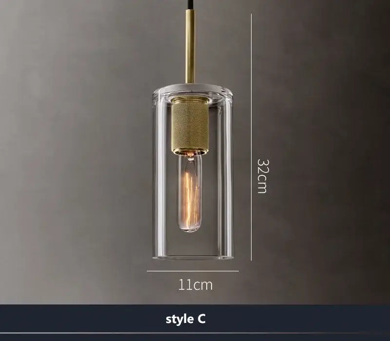 Modern gold and clear glass led pendant light with cylindrical shade and brass accents for dining room lighting