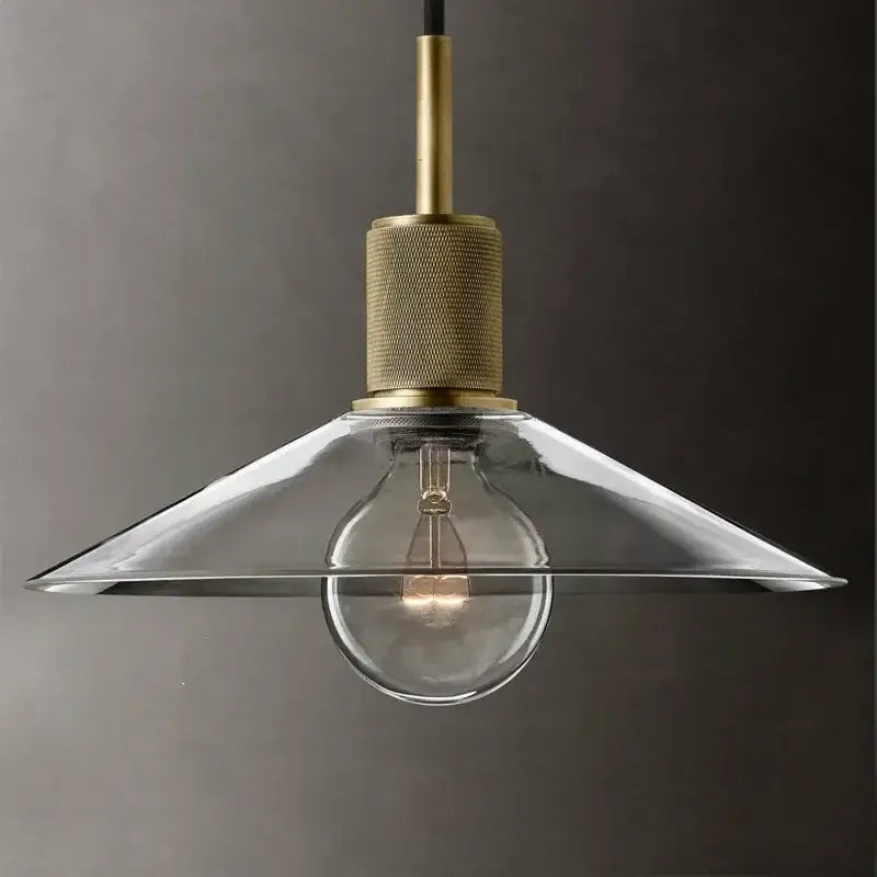 A clear glass led pendant light with brass finish and exposed bulb for modern gold dining room pendant lighting