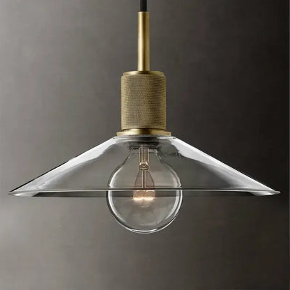 A clear glass led pendant light with brass finish and exposed bulb for modern gold dining room pendant lighting