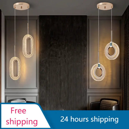 Three modern gold and crystal oval bedside pendant lights with metal frame hang from ceiling for bedroom decor