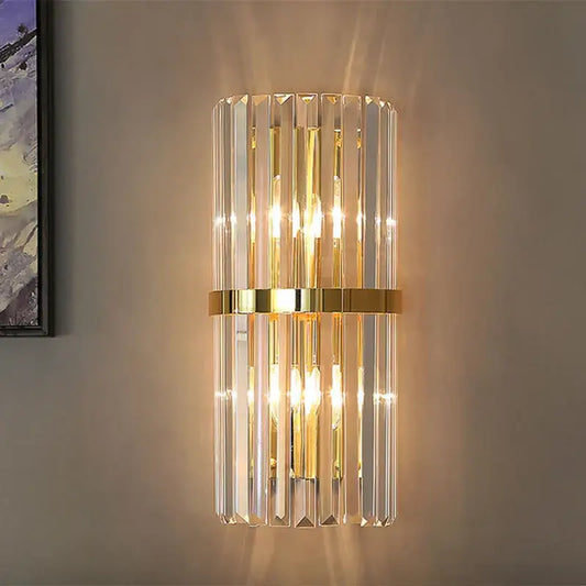 A modern gold and crystal wall light with vertical crystal rods and polished gold band for living room decorbites crystal wall