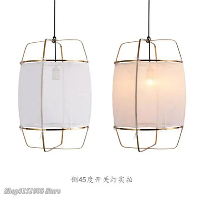 Modern pendant light fixture with brass-colored cylindrical frame and translucent bamboo linen shade for dining room decorbites