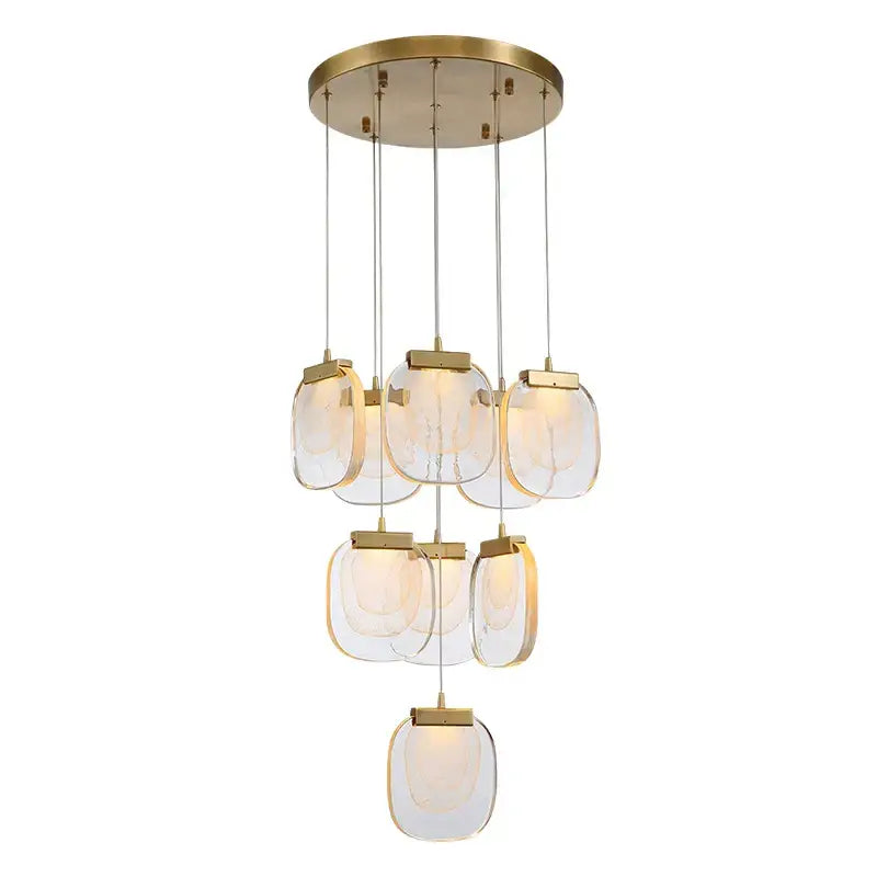 Modern brass-finished pendant lights with tiered translucent glass pendant shades for dining room lighting