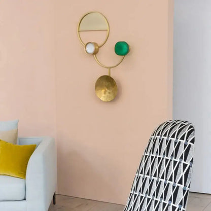 Modern gold and green orbit wall sconce wall lamp with geometric design, circular mirror, and hammered disc base