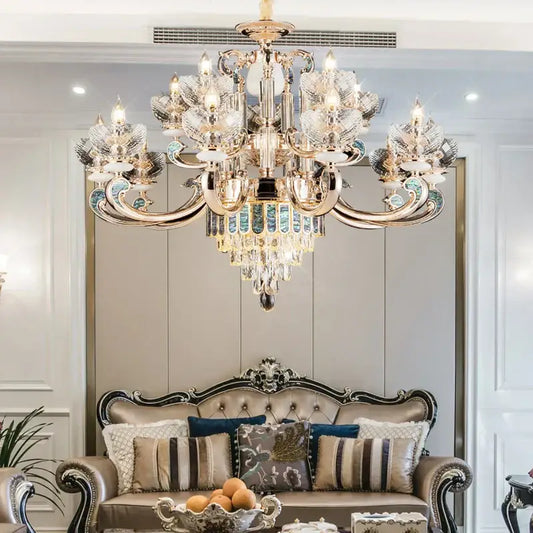Modern gold and teal crystal candle chandelier with decorbites crystal accents hanging above a luxurious sofa