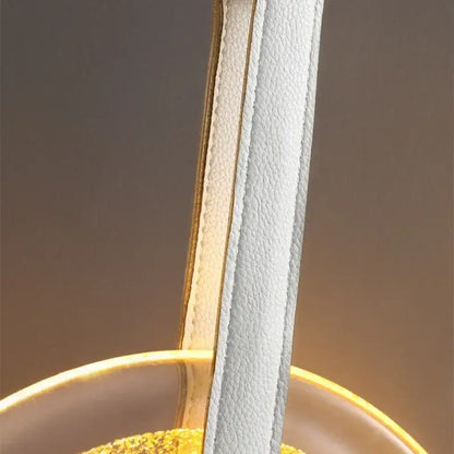 White leather strap with gold-toned stitching and trim on modern gold and white circular glass led chandelier by decorbites