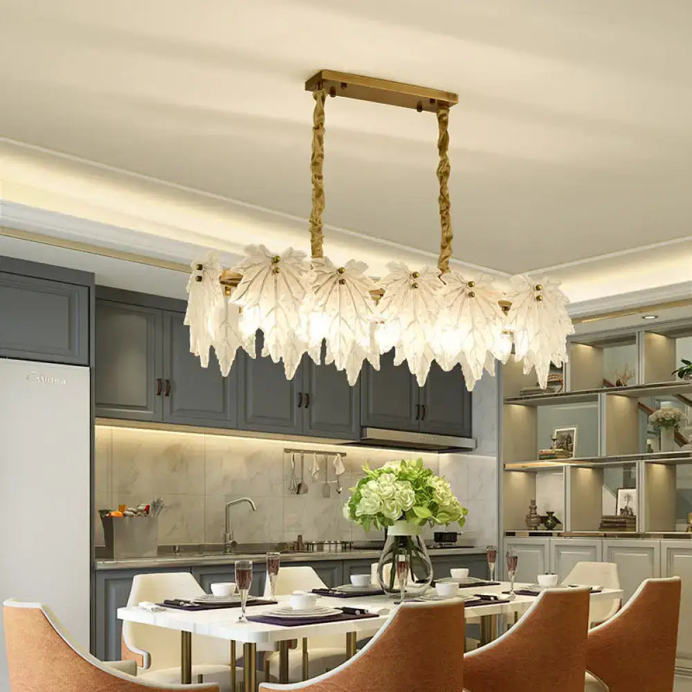 Modern gold pendant light fixture with white glass floral shades and twisted chain frame for dining room use
