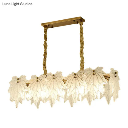 Modern gold and white glass floral pendant light fixture with leaf-shaped white glass shades for dining room use