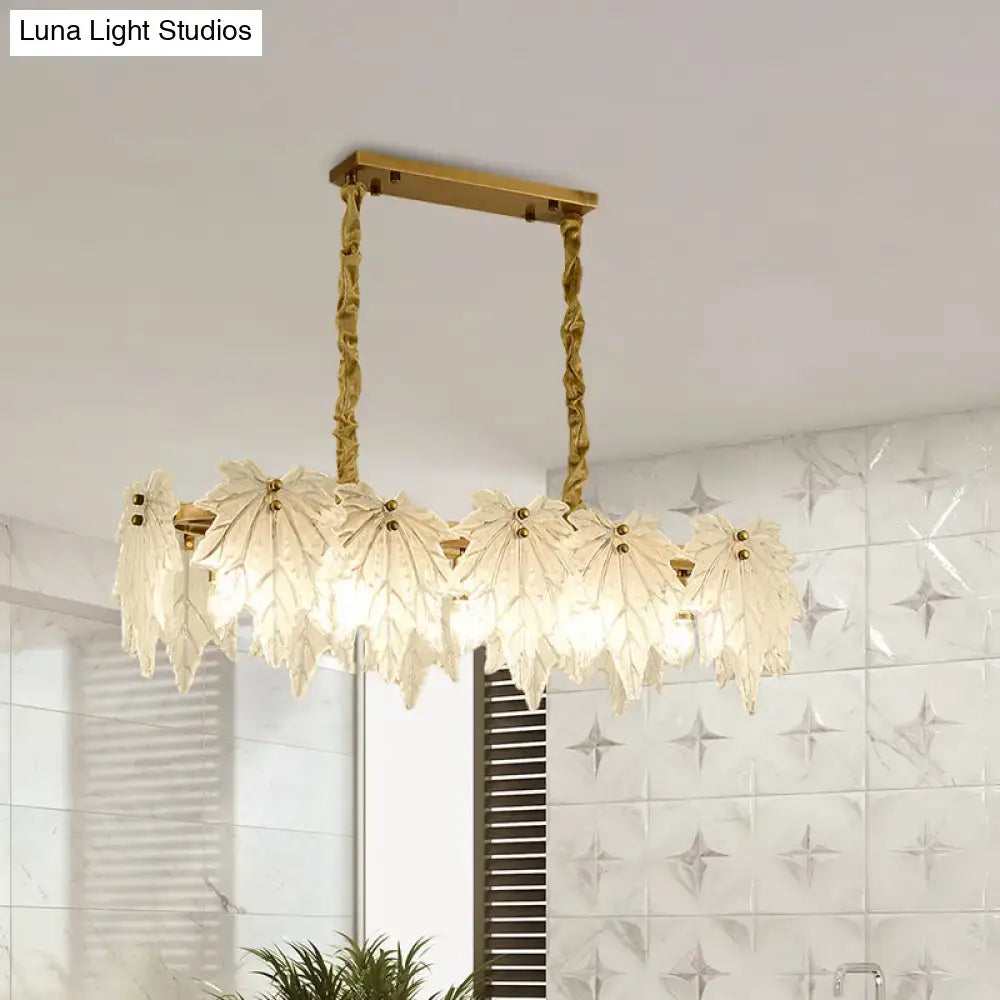 Modern gold and white glass floral pendant light with gold-toned leaf design and twisted metal chains light fixture