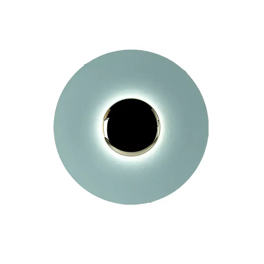 A sleek circular led ufo wall sconce with matte teal diffuser and polished chrome ring for modern bedroom ambiance