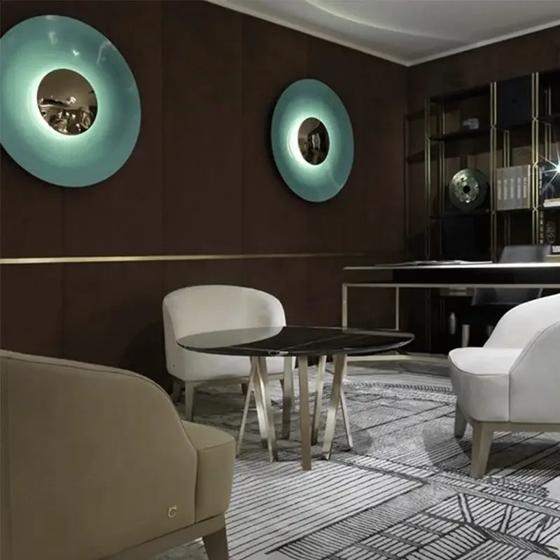 Two teal glossy circular led ufo wall sconces with reflective centers for modern bedroom ambiance lighting