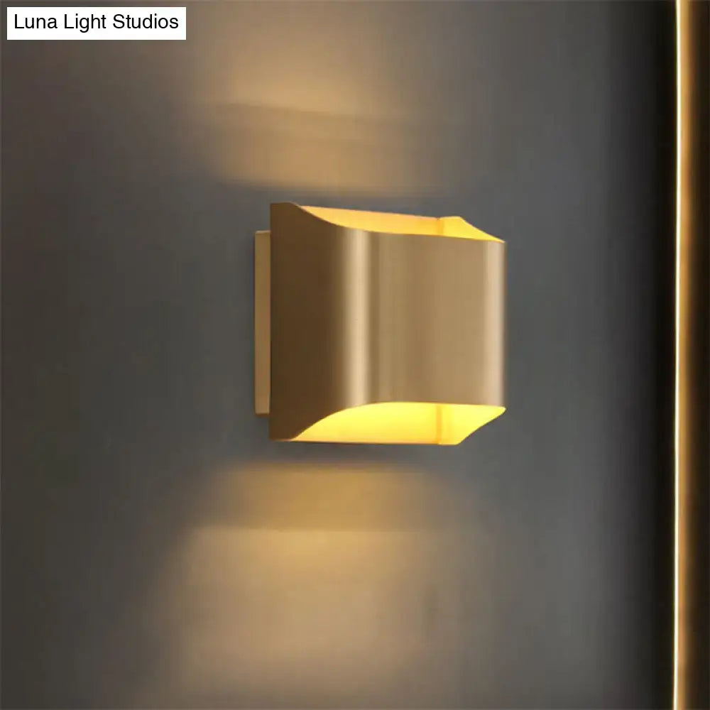 Modern gold angular led light fixture with sleek design casting warm light perfect for living room illumination