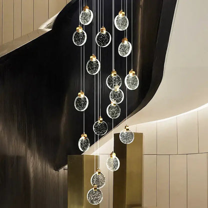 Modern gold attic crystal chandelier with glass orbs embedded with sparkling particles for dining room lighting