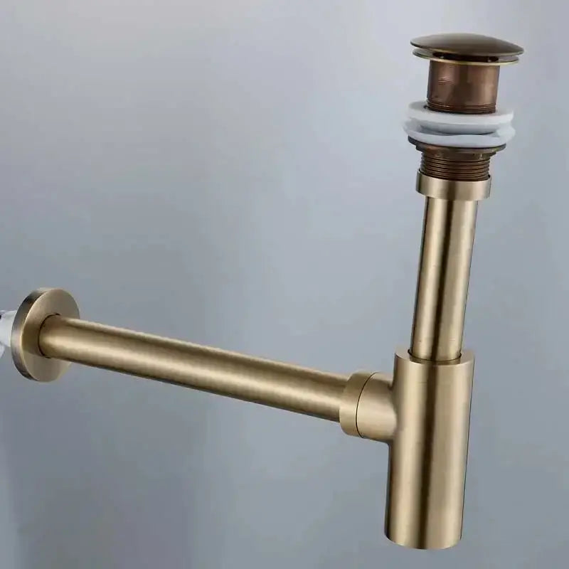 Brass-colored modern gold basin tap kit drain pipe with cylindrical stopper and white rubber seal for bathroom use