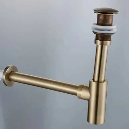 Modern gold basin tap siphon kit featuring a brass-colored drain pipe with cylindrical stopper and white rubber seal