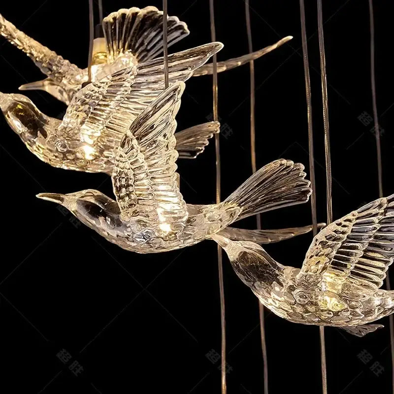 Modern gold bird design led chandelier with clear glass birds featuring intricate feather details and internal lighting
