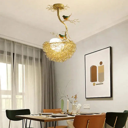 Modern gold bird nest glass pendant lights feature a golden bird-themed ceiling light with intricate branch design