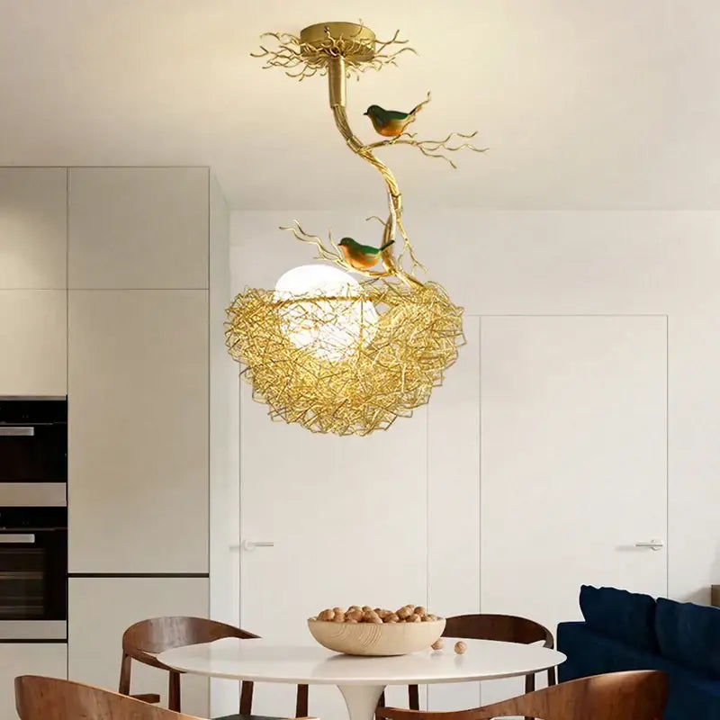 Modern gold bird nest glass pendant lights feature a golden bird-themed ceiling light fixture with intricate branch design