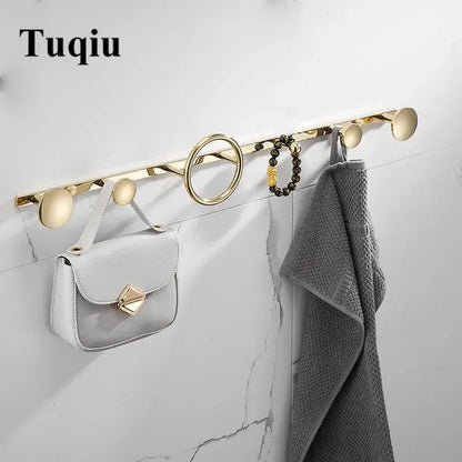 Modern gold and black brass towel hook set with sleek circular and oval wall-mounted hooks for bathroom use