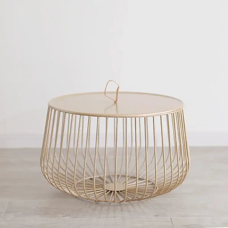 A sleek gold-toned wireframe coffee table with a round top, ideal for modern living room decor by decorbites gold pumpkin