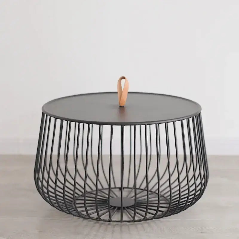Modern gold and black coffee table with black wireframe, matte top, and light brown leather handle for decorbites gold pumpkin coffee decor