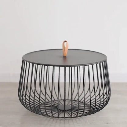 Modern gold and black coffee table with black wireframe, matte top, and light brown leather handle for decorbites gold pumpkin coffee decor