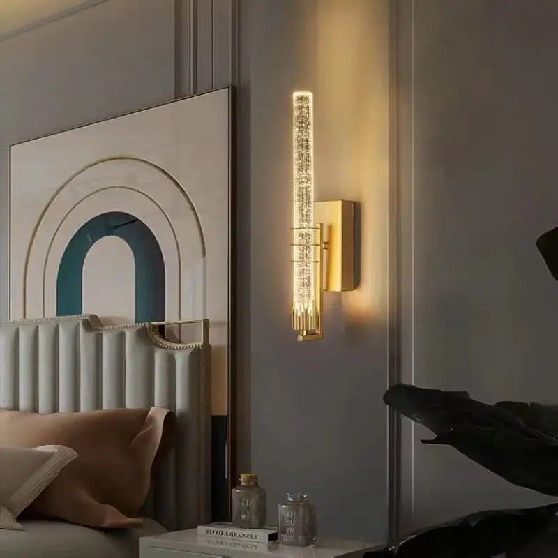 Modern gold and black decorbites crystal led wall sconce with vertical textured glass panel emitting warm light