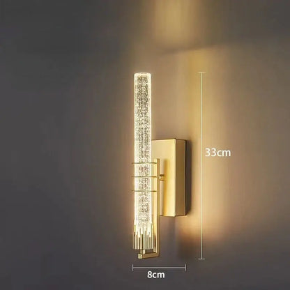Modern gold and black crystal led wall sconce featuring a gold-toned backplate and vertical crystal encrusted light fixture decorbites crystal led