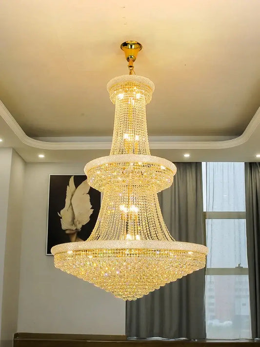 Modern gold and black pendant light with tiered metal finish and cascading crystal beads for dining room chandelier
