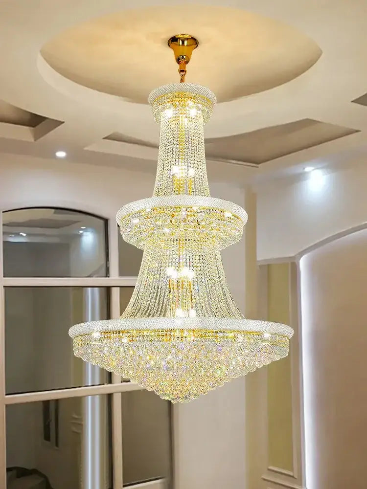 Modern gold and black crystal pendant light with gold-toned metal finish and cascading crystals for dining room use