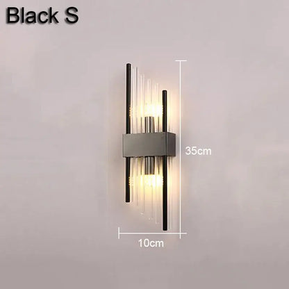 Modern gold and black decorbites crystal wall lamp with sleek metallic frame and clear glass rods emitting warm light