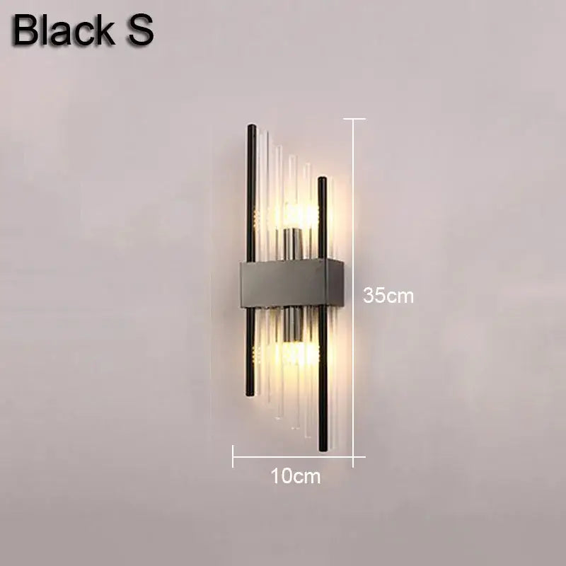 Modern gold and black decorbites crystal wall lamp with sleek metallic frame and clear glass rods emitting warm light