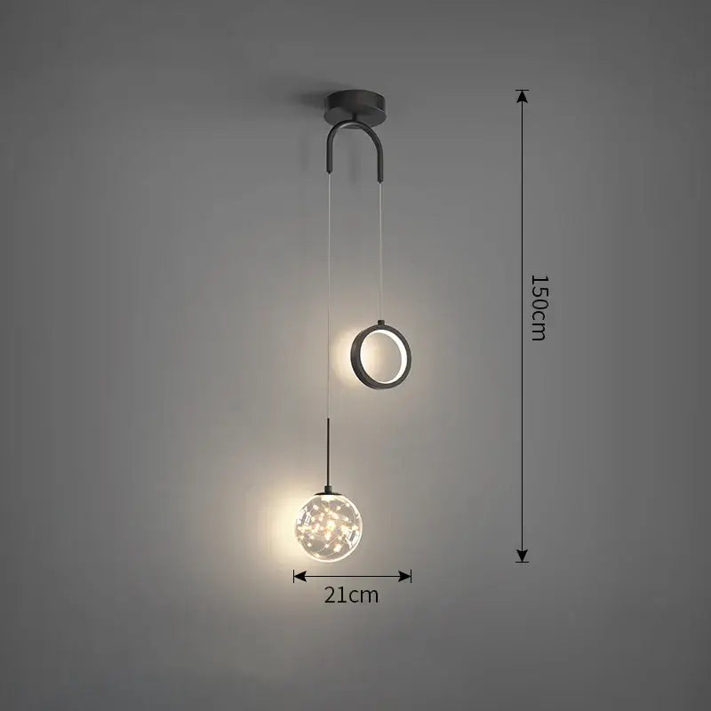 Modern black metal pendant light with gold and black glass globe featuring warm selectable light colors for dining rooms
